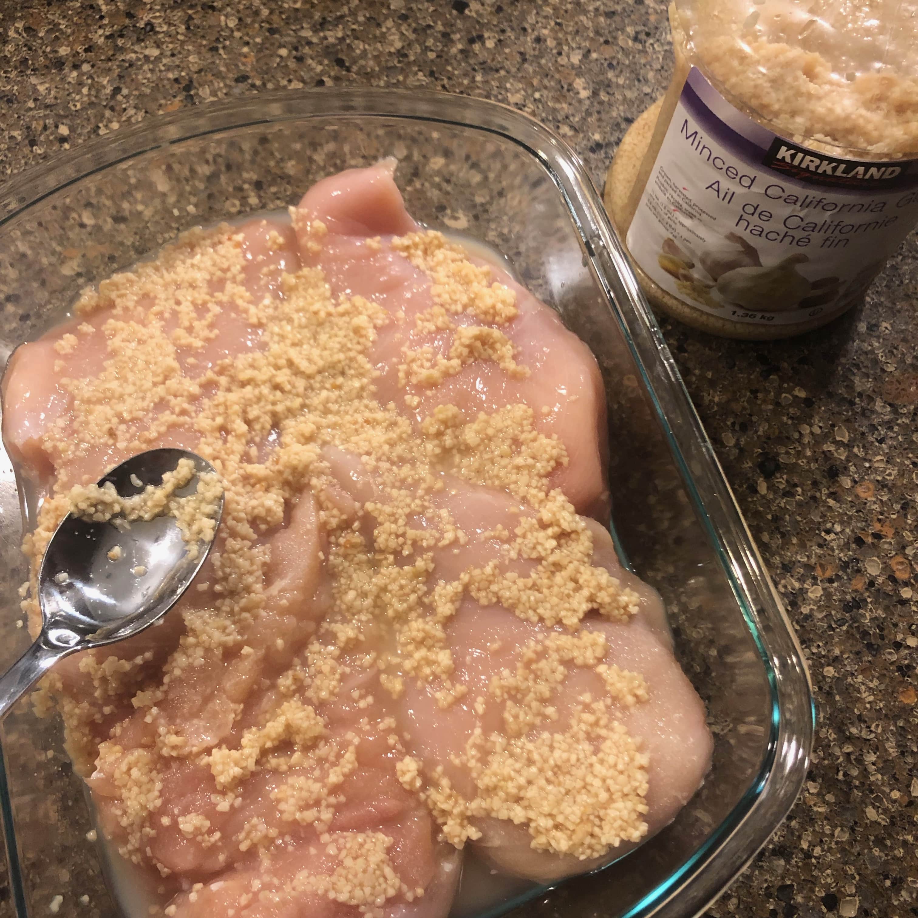 raw chicken breasts with garlic